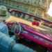 Taxi driver in a traditional hat driving a vintage car in Old Havana, Cuba.