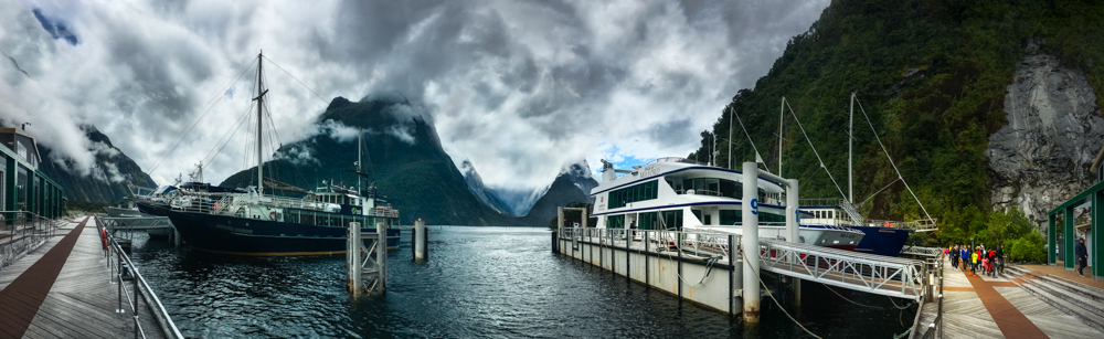 Cruise boats at Milford Sound Marina on a cloudy day. in New Zealand