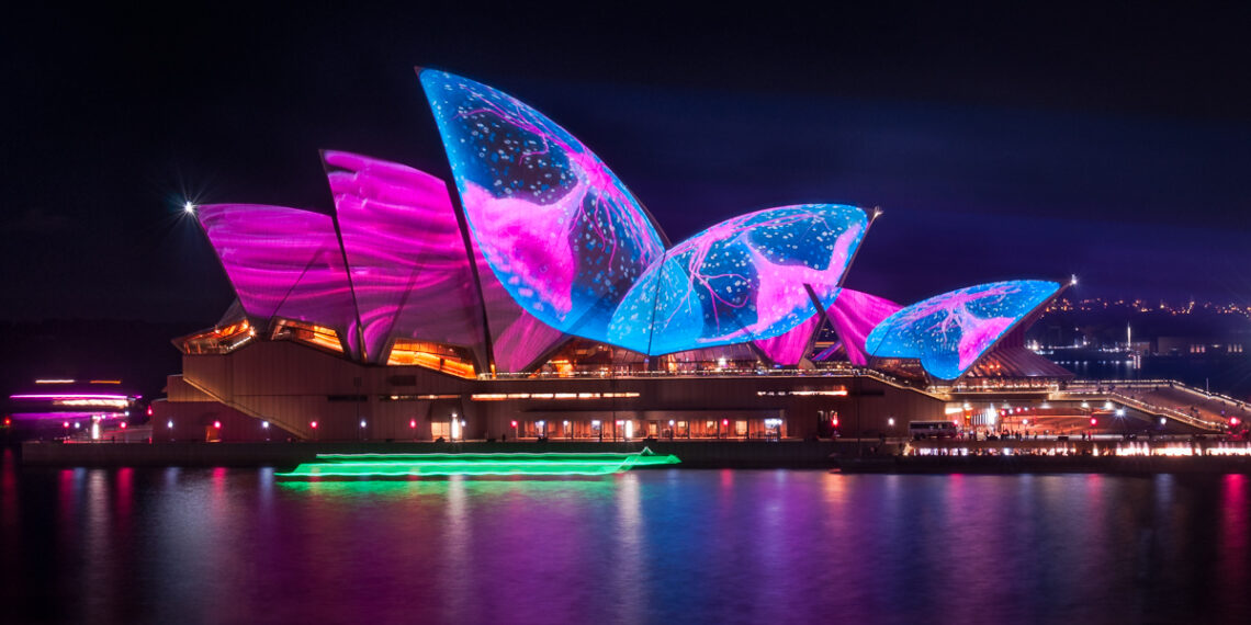 Illuminating Opera House's roofs with an art work representing a pulsating sea creature in amazing colors at Vivid Sydney Festival in 2017, in Australia.